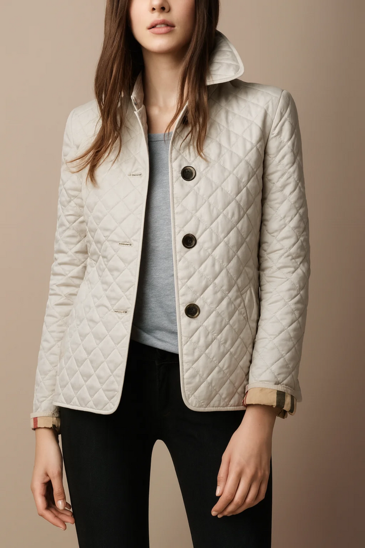 Woman wearing white quilted jacket with button front and plaid cuffs