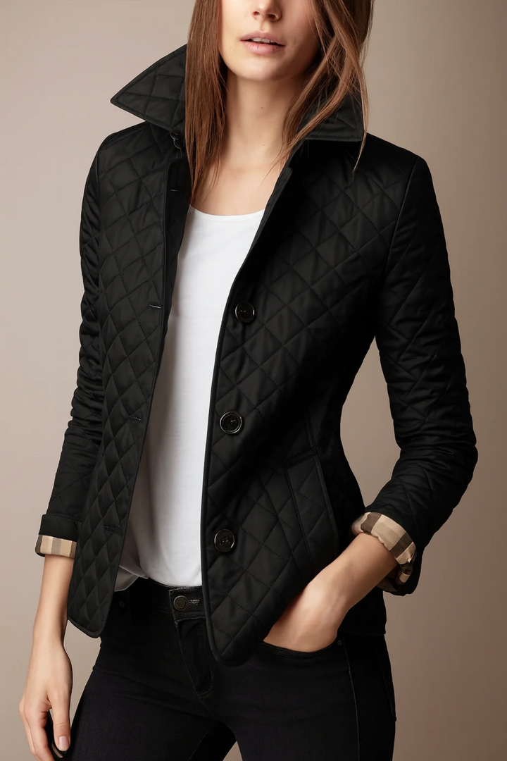 Woman wearing black quilted jacket with hands in pockets