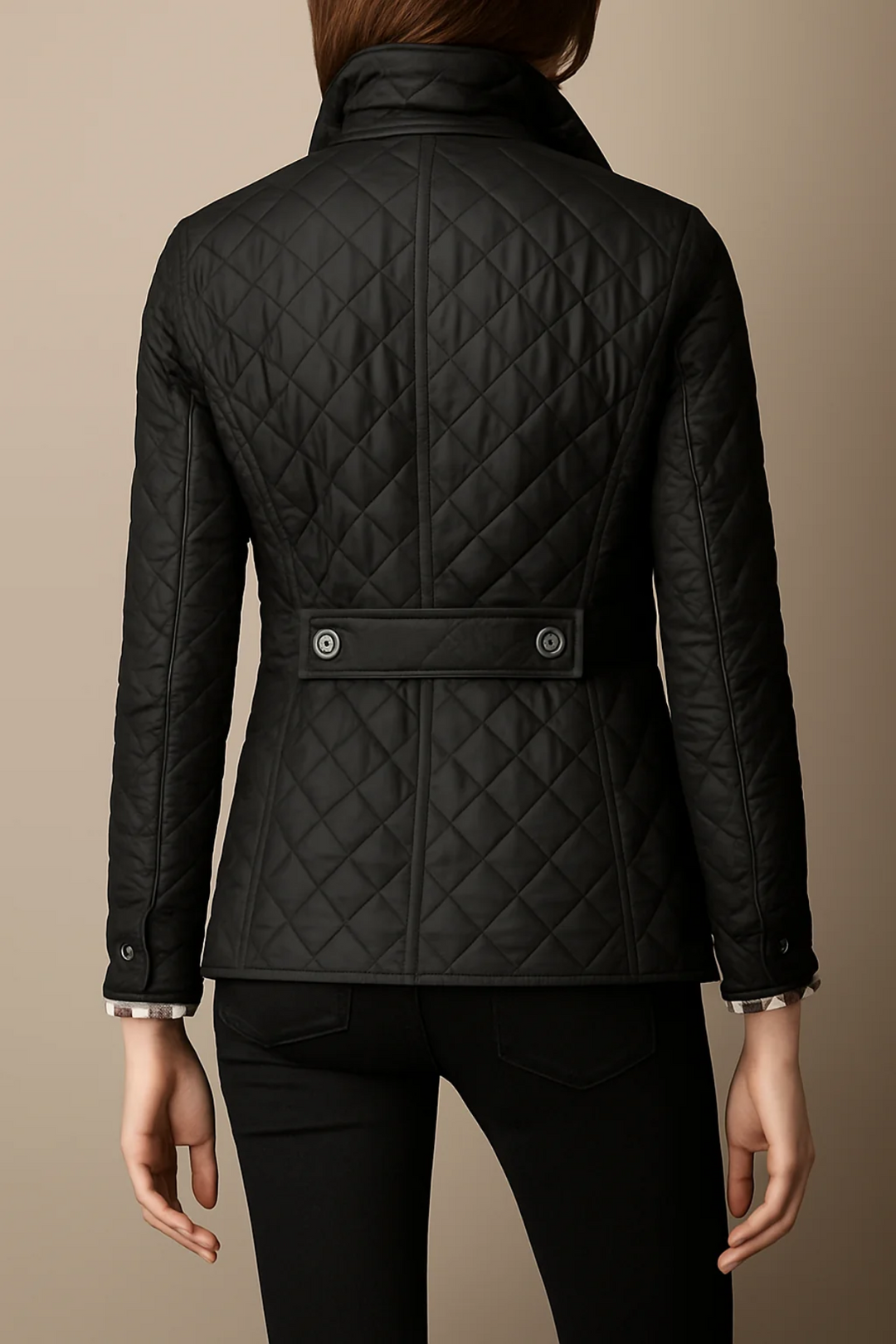 Back view of black quilted jacket with waist tab detail